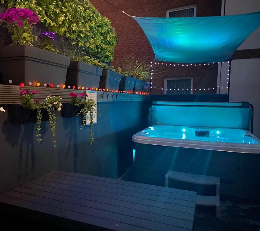 a jacuzzi tub in the middle of a patio at 3 The View apartments Ilfracombe - Hot Tub, Parking, Lift, EV in Ilfracombe