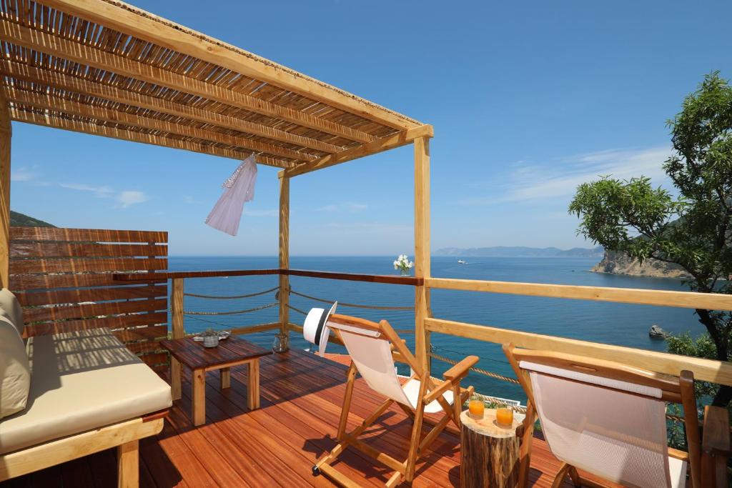 a balcony with chairs and a view of the ocean at Skopelos Aerino house in Skopelos Town