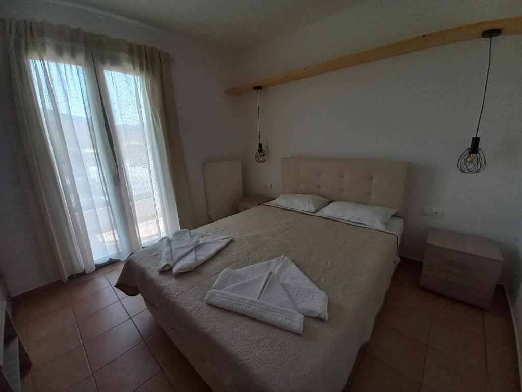Posteľ alebo postele v izbe v ubytovaní Achilli Apartments