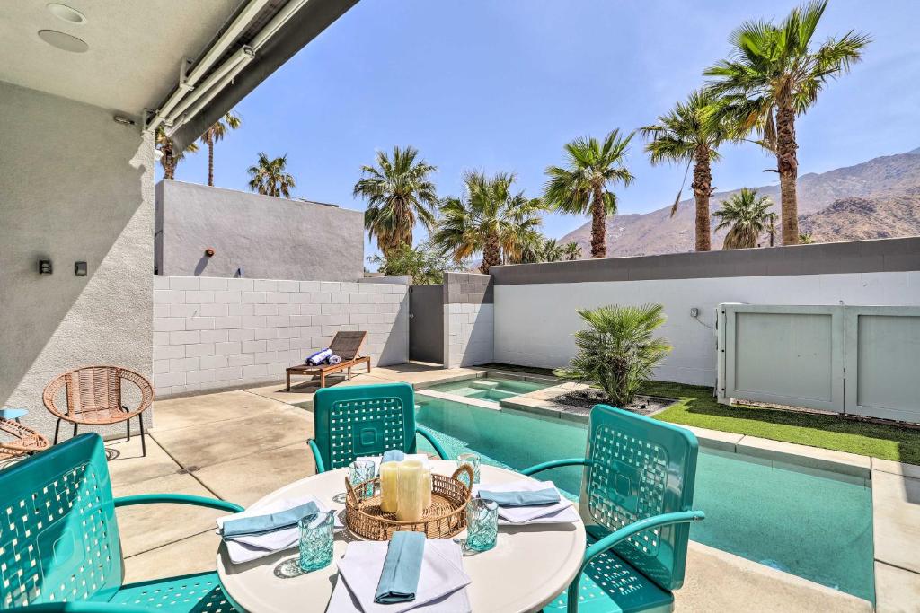 a patio with a table and chairs next to a swimming pool at Mid-Century Modern Home with Pool Hike and Golf in Palm Springs