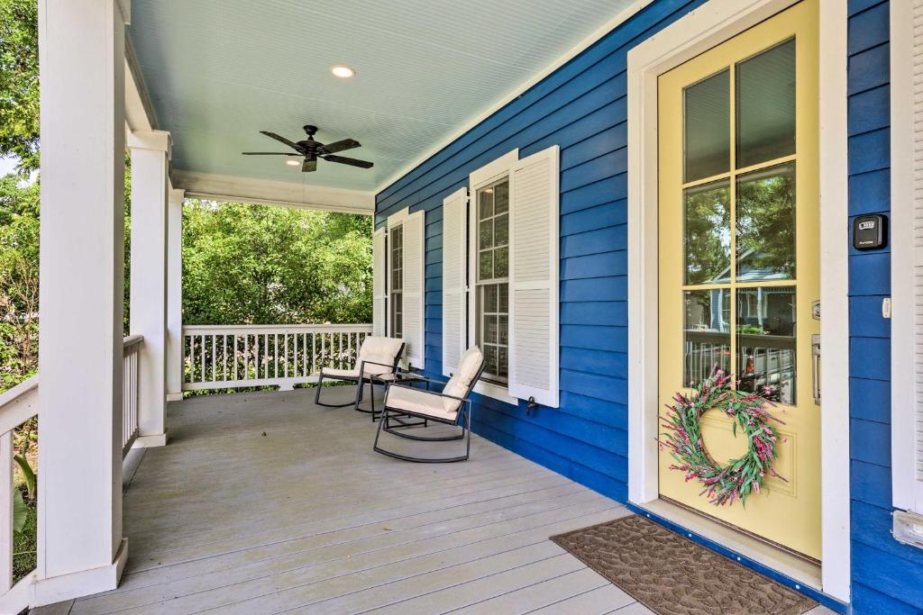 a front porch with two chairs and a ceiling fan at Lovely Mobile Retreat with Deck and Front Porch! in Mobile