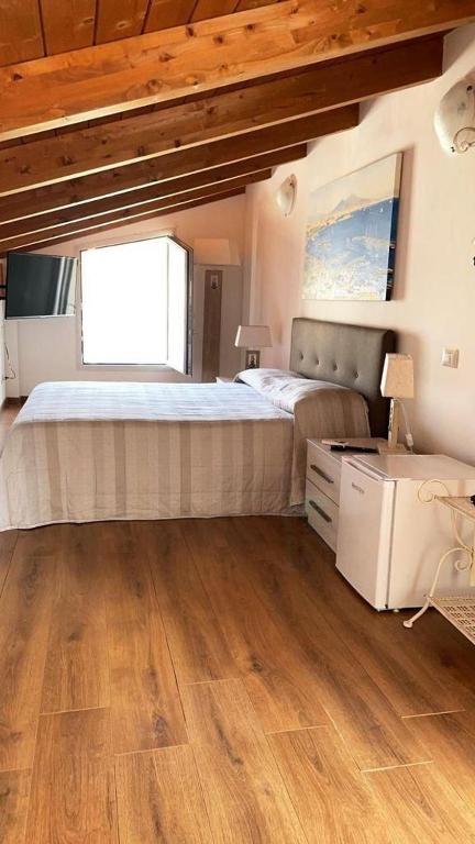 a bedroom with a large bed and a window at Emma's house in Sorrento