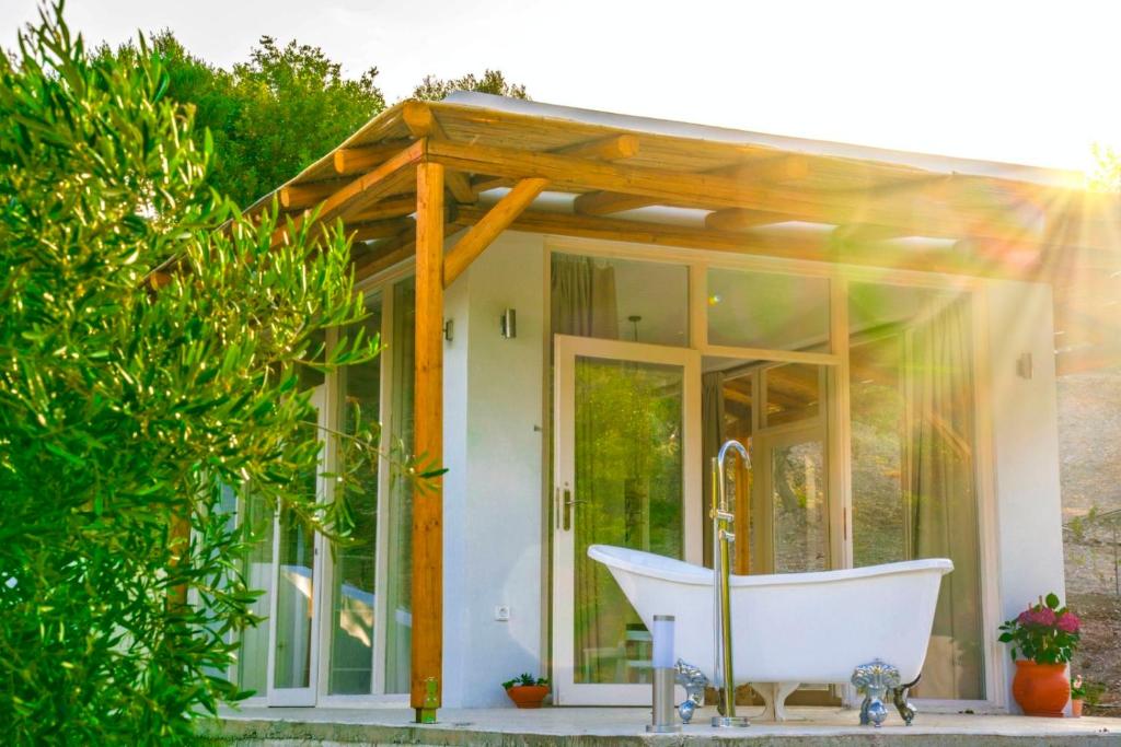 a bath tub in front of a small house at Panstel Bungalows in Kerames Rethymno in Kerames