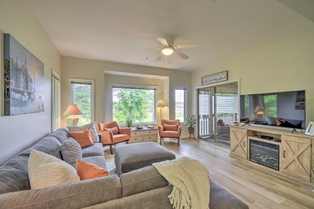 a living room with a couch and a flat screen tv at North Myrtle Beach Condo with Golf Course Views in North Myrtle Beach