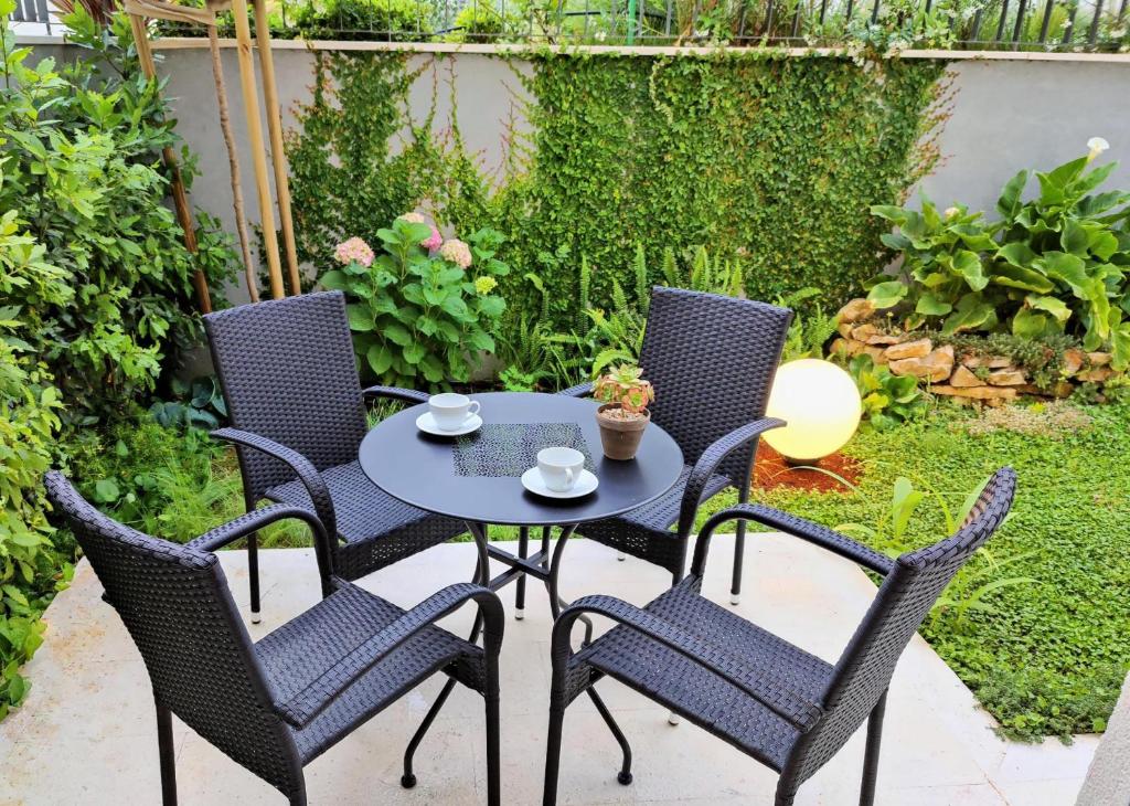 a table and four chairs on a patio at R&R Residence Podstrana in Podstrana