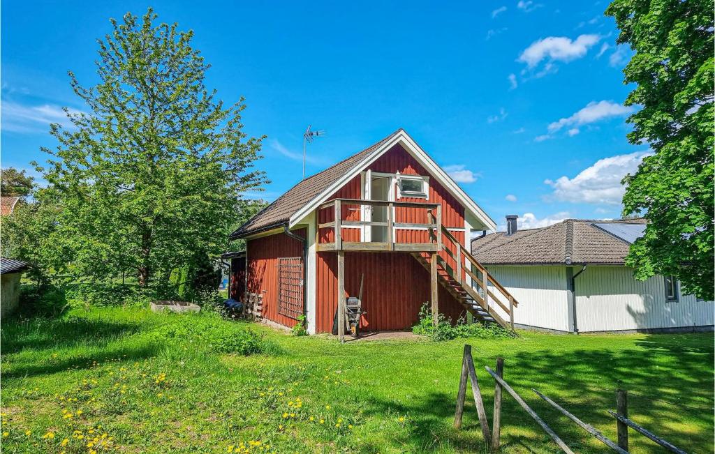 a red barn with a deck on the side of it at Stunning Apartment In Gullspng With Wifi in Gullspång