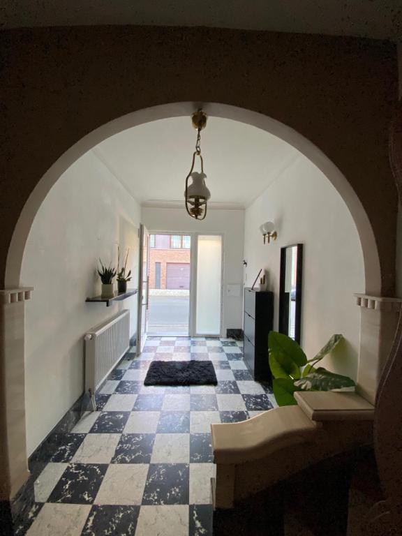 an arched hallway with a black and white checkered floor at Big Sunset 3 Bedroom House with a Garden in Antwerp