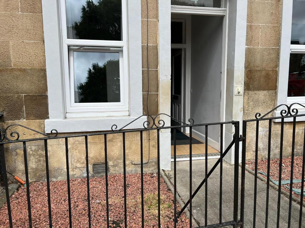 a wrought iron fence in front of a building at Murrayfield apartment in Edinburgh