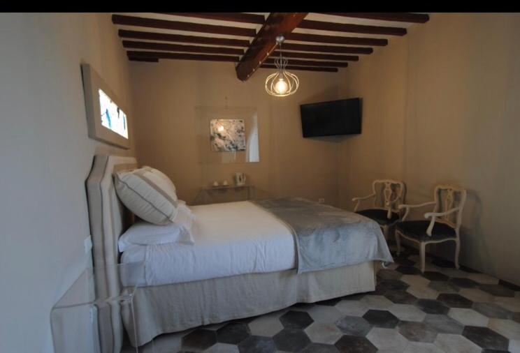 a bedroom with a bed and a table and a television at Vinci - Idea Resort - Tuscany in Vinci