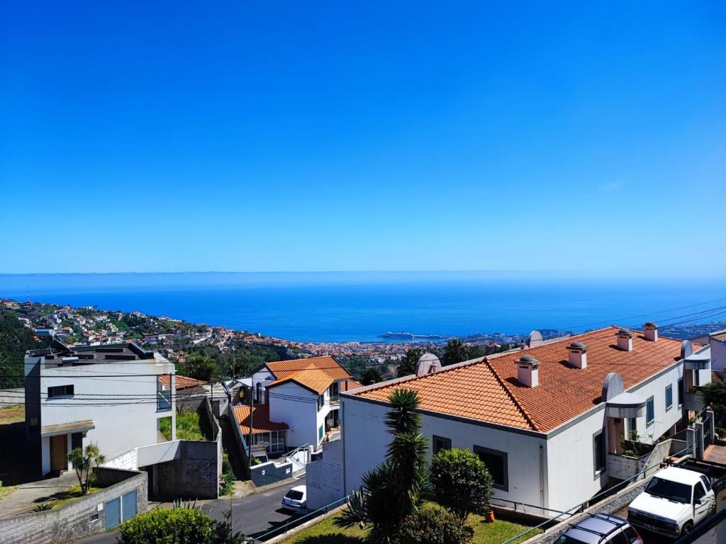 a view of a house with the ocean in the background at Casa Alegria in Funchal