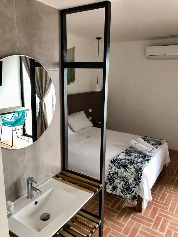 Postel nebo postele na pokoji v ubytování Hotel Macaw Cúcuta