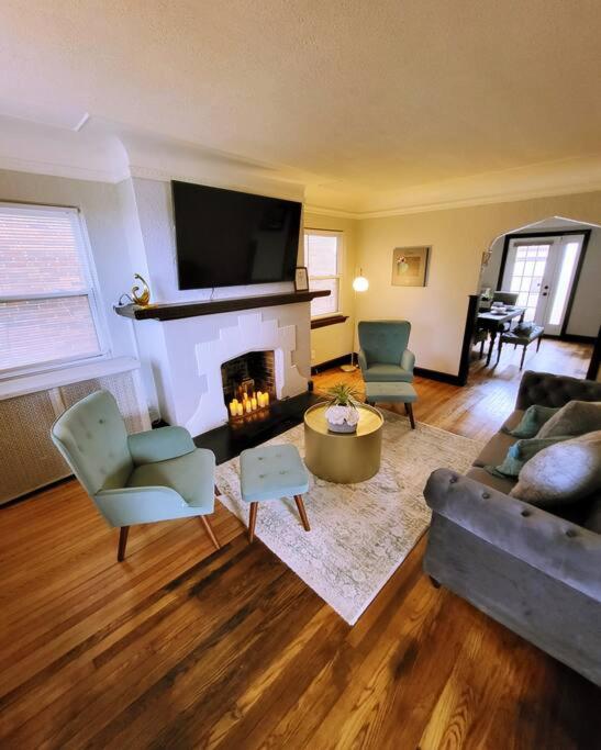 a living room with a couch and a fireplace at Vintage Charm, E. Eng. Village, 10mins to Dt. Det. in Detroit