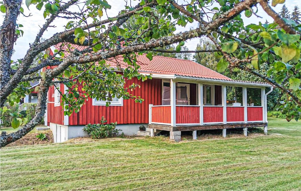 a red house with a red roof on a yard at Beautiful Home In Sunnemo With Wifi And 2 Bedrooms in Sunnemo