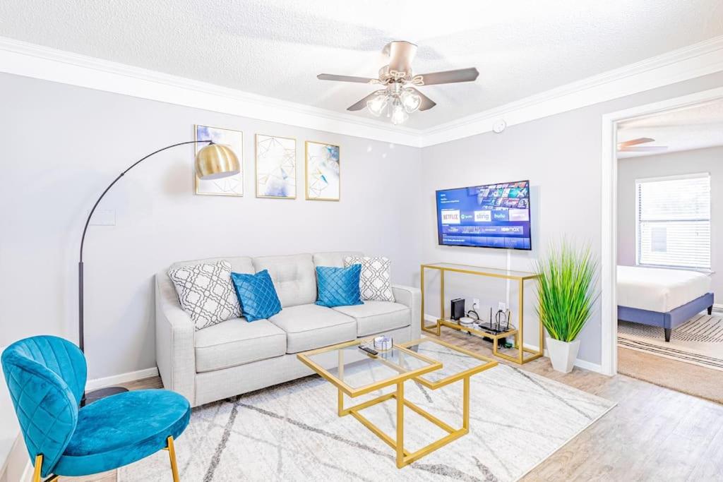 a living room with a white couch and a blue chair at Central 1BR King Bed Suites, Close to Downtown & Domain in Austin