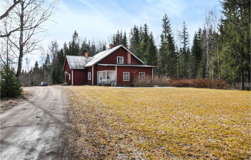 a red house in the middle of a field at 5 Bedroom Nice Home In Södra Rådom in Södra Rådom