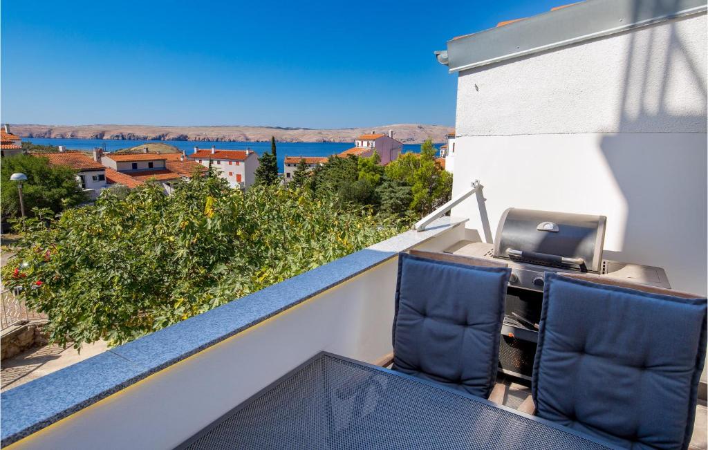 a balcony with two chairs and a printer on a roof at Gorgeous Apartment In Stinica With Kitchen in Stinica