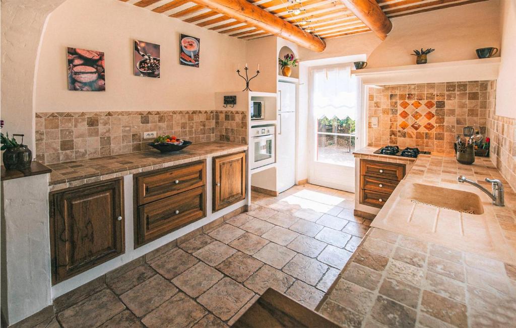 a large kitchen with a sink and a counter at Gorgeous Home In Lioux With Wifi in Lioux