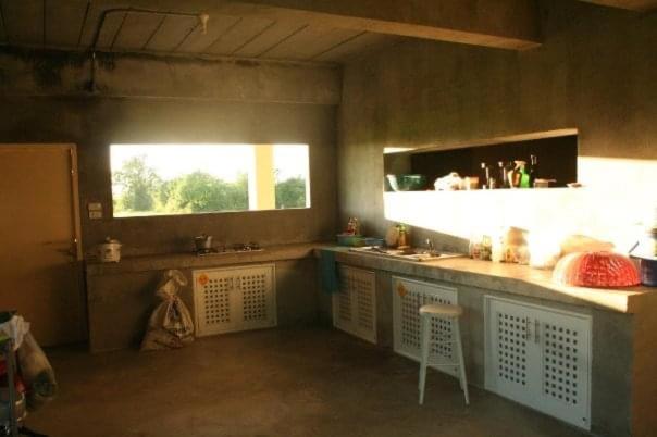 a kitchen with a counter and a sink and a window at Starry Night hostel in Ban Mae Chong