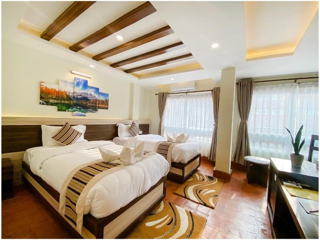 a bedroom with two beds in a room at Satkar Boutique Home in Kathmandu