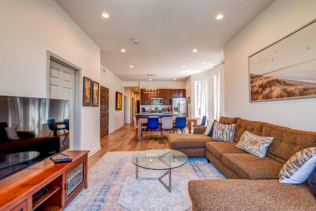 a living room with a couch and a table at Spacious 5-BR Apt next to transit Free Parking in Chicago