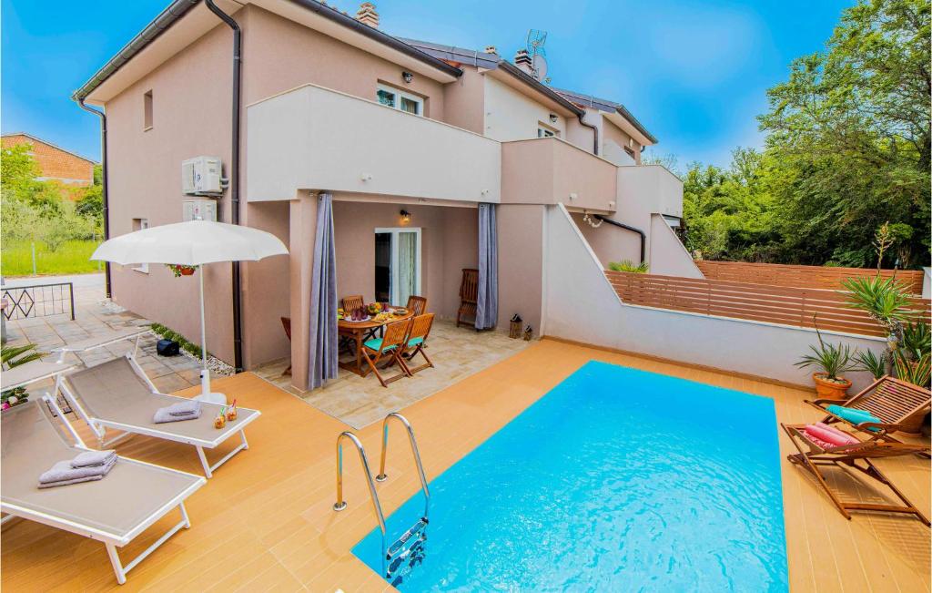 a villa with a swimming pool in front of a house at Awesome Home In Klimno With 2 Bedrooms, Wifi And Outdoor Swimming Pool in Klimno