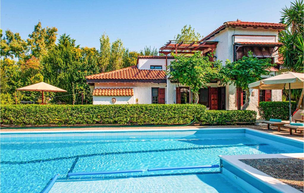una casa con piscina frente a una casa en Villa Melenia, en Maratón