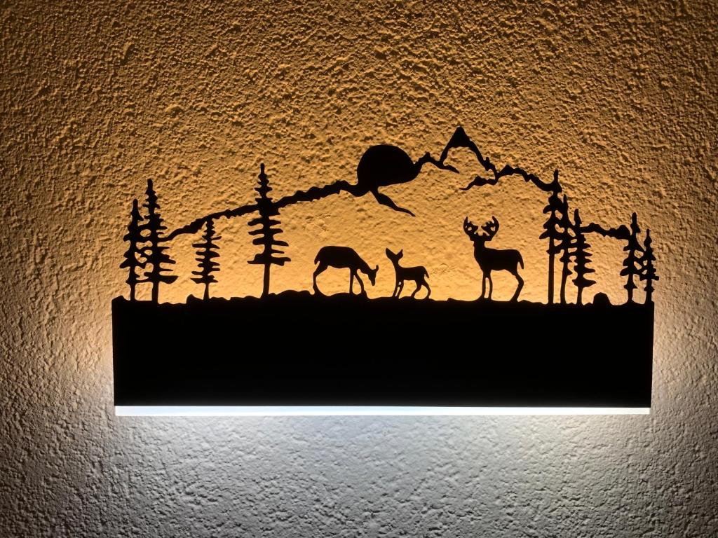 a wall with a silhouette of animals on it at CASA CARCENTINA in Bormio
