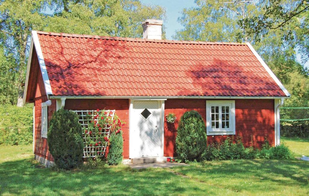 a red small house with a red roof at Holiday Home Hörlösa Löttorp in Gamleby