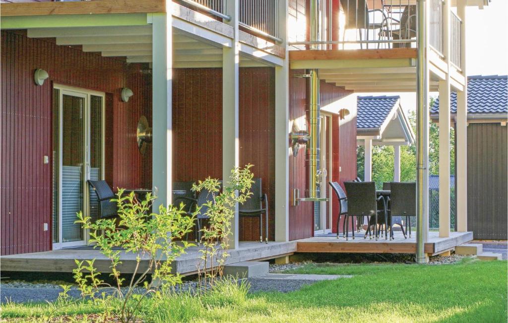 a porch of a house with chairs and a table at Ferienhausdorf Thale in Thale