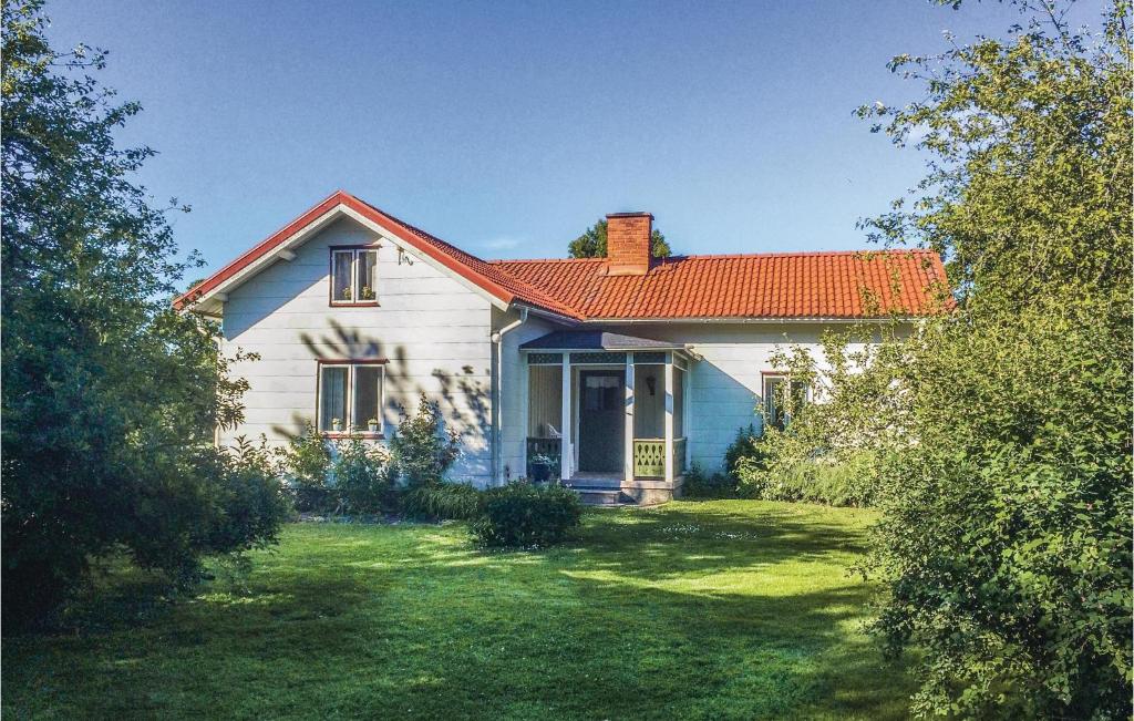 Sjövik的住宿－1 Bedroom Beautiful Home In Lidkping，白色的房子,有红色的屋顶和院子