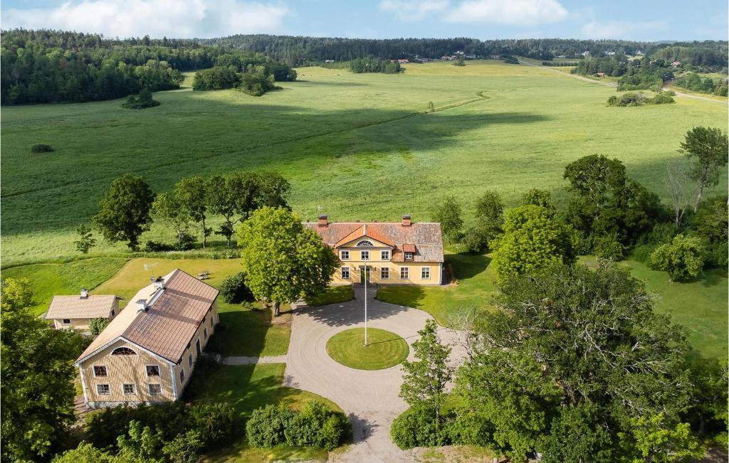 an aerial view of a large house in a field at Gorgeous Home In Hl With Kitchen in Hölö