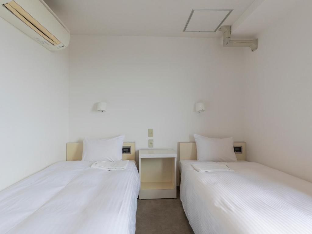 Postel nebo postele na pokoji v ubytování Tabist Hotel Yuan Akashi