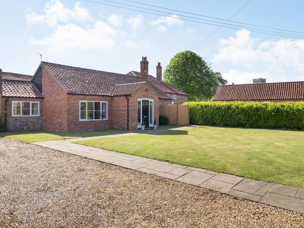 a brick house with a lawn in front of it at The Croft in Thetford