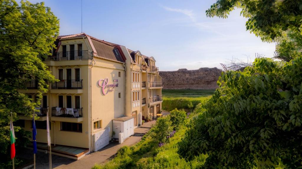 a building with graffiti on the side of it at C Comfort Hotel & Wellness in Hisarya