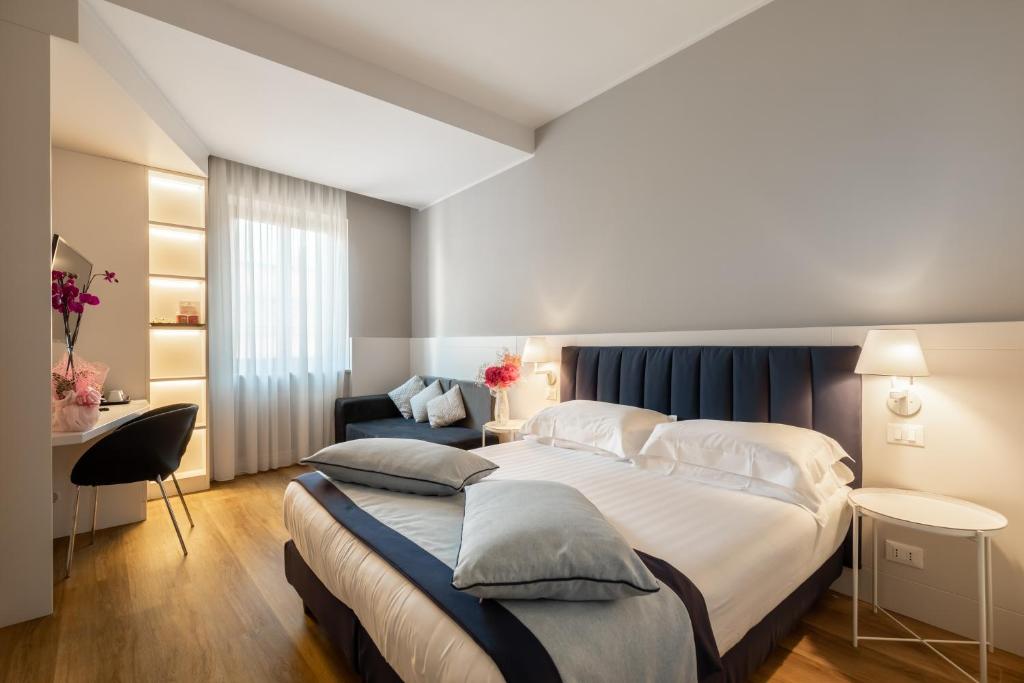 Llit o llits en una habitació de Hotel La Rovere