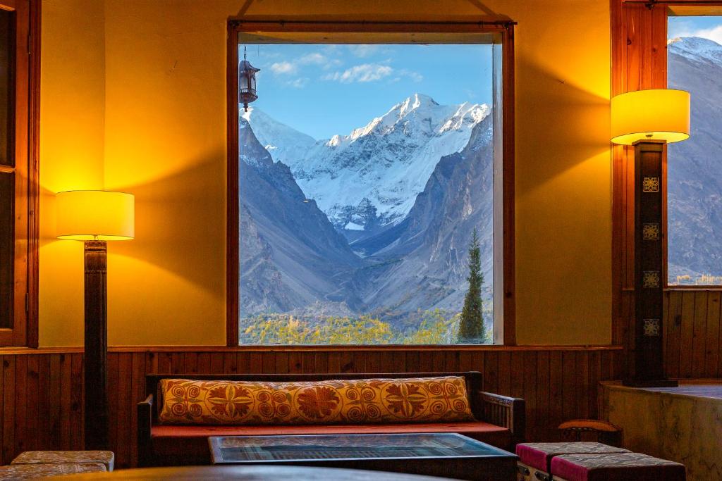 a room with a window with a view of a mountain at Roomy Daastaan Hotel, Karimabad Hunza in Hunza Valley