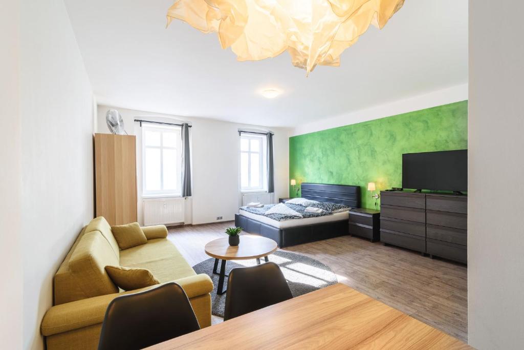 uma sala de estar com um sofá e uma cama em Pilsner Apartments em Plzeň