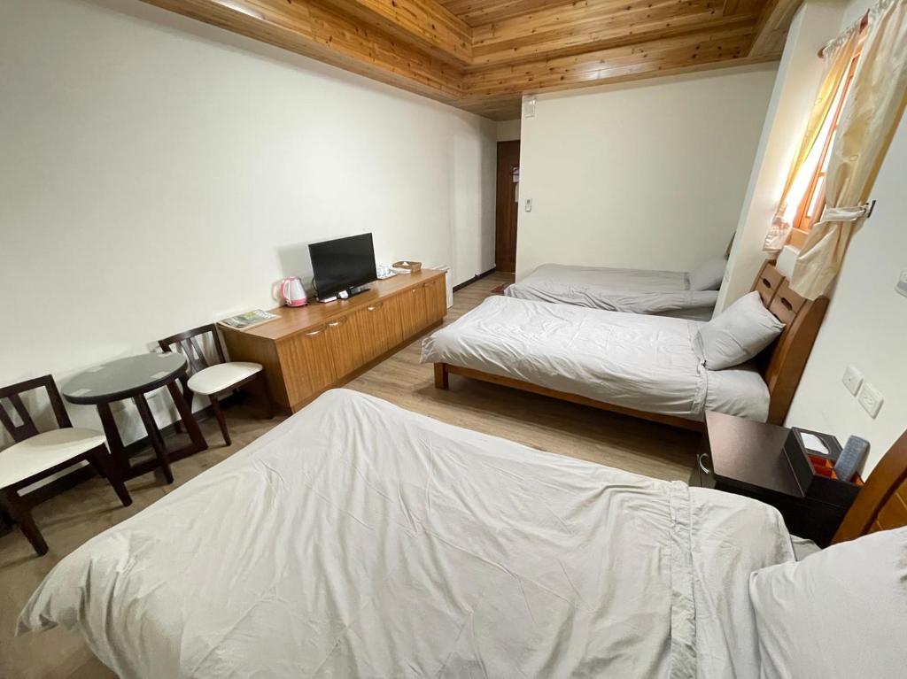Postel nebo postele na pokoji v ubytování 芹壁山城民宿 Chinbe Hill Village House B&B