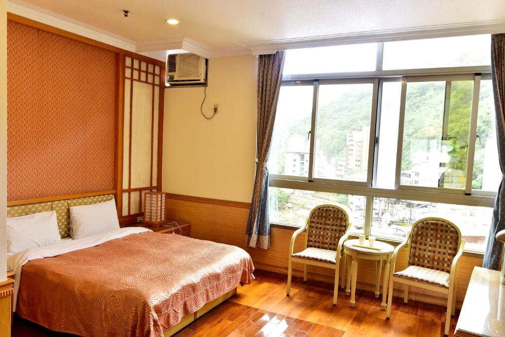 Postel nebo postele na pokoji v ubytování Jenq Yang Hotspring Hotel