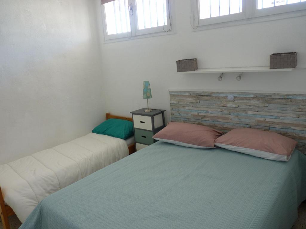 Een bed of bedden in een kamer bij Sol-y-Days Hesp&eacute;rides, Appartement familial 5 couchages, quartier calme &agrave; 50m de la plage