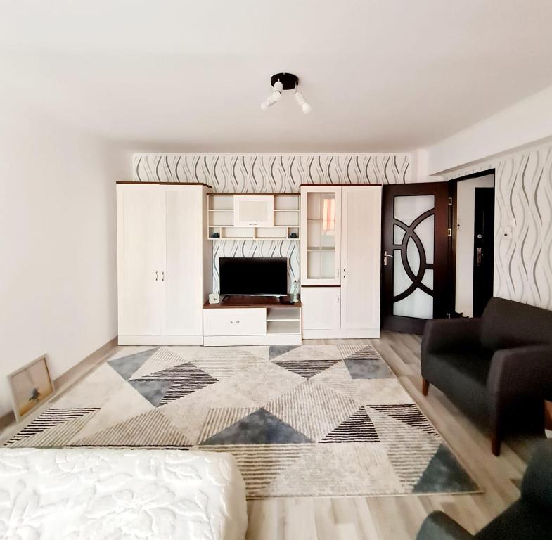 a living room with a bed and a couch at Garsoniera in Roman