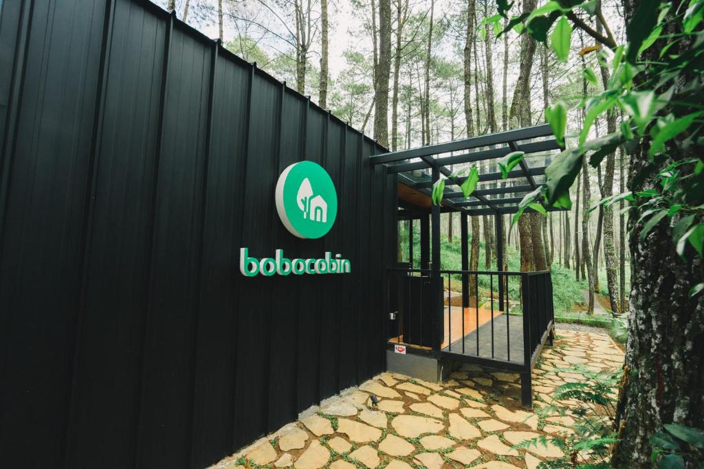 a black fence with a biohazard sign on it at Bobocabin Cikole, Bandung in Lembang