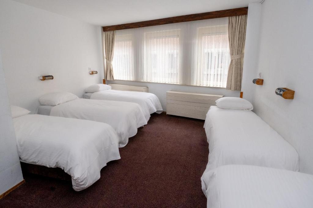 Voodi või voodid majutusasutuse Hotel Ben Centre toas