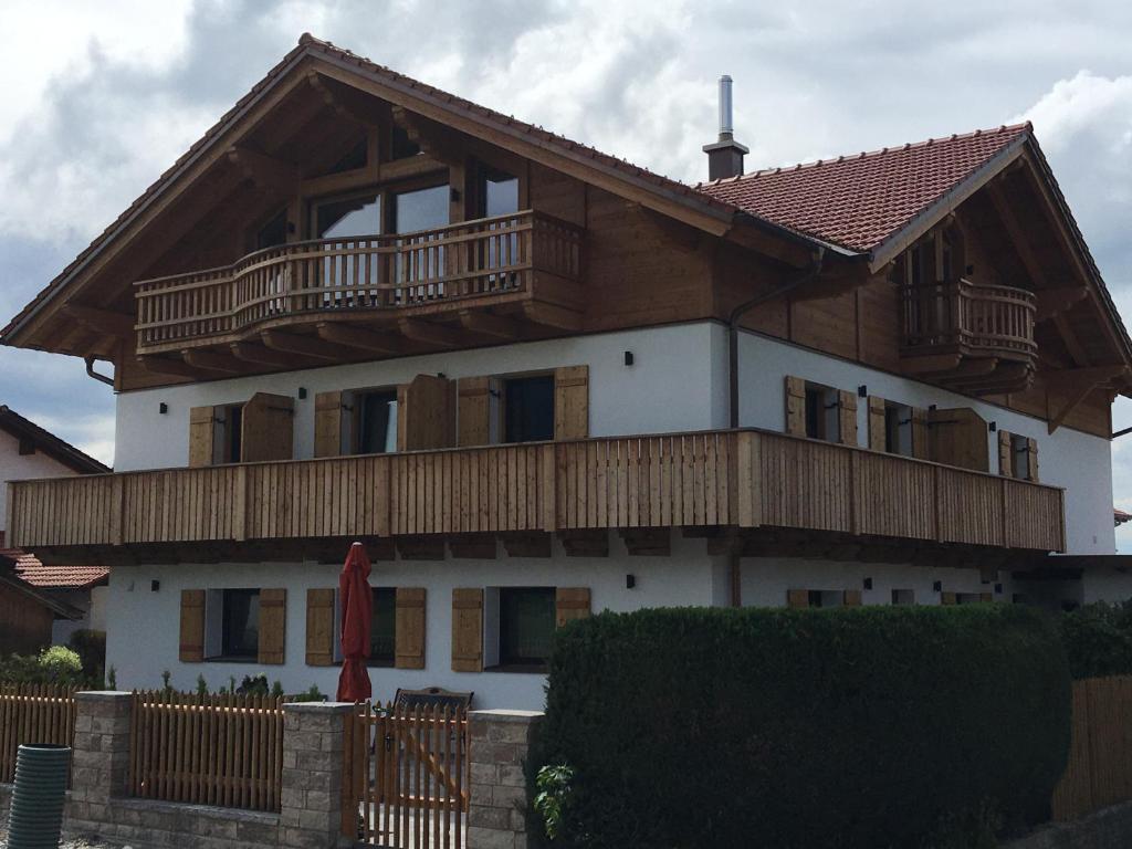 a large wooden house with a balcony on top of it at Gästehaus Apollo in Schwangau