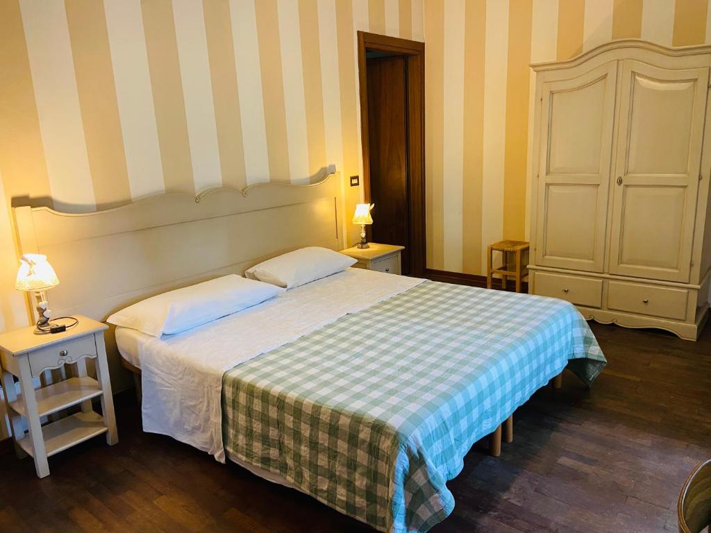a bedroom with a bed with a checkered blanket at B&B Al Ponte in Padova