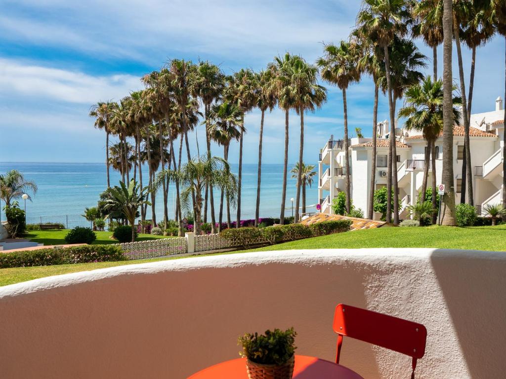 a view of the ocean from the balcony of a resort at MD002 Precioso apartamento en primera linea de playa in Sitio de Calahonda