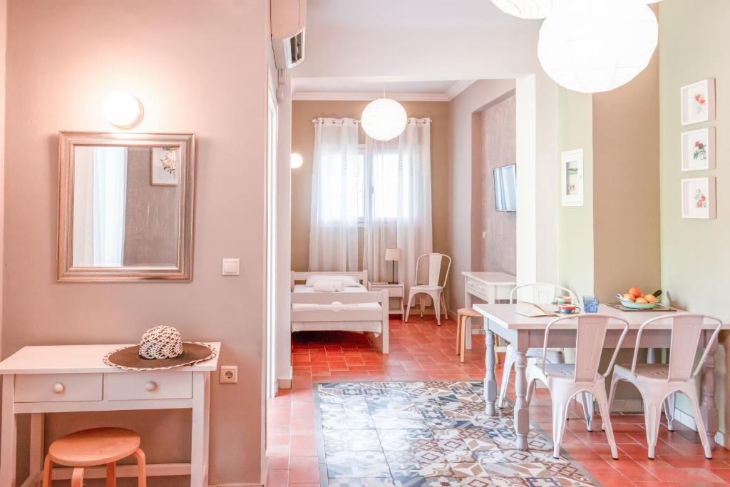 a living room with a table and a dining room at Dimitra's Garden - Holiday Apartments in Parga