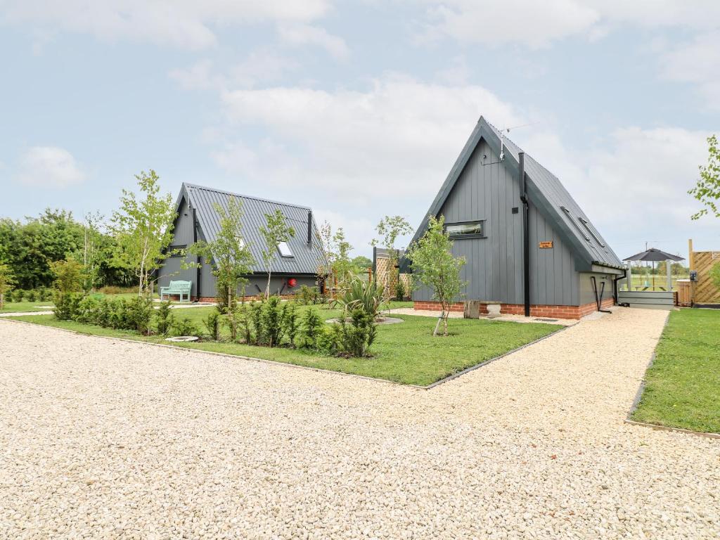 a barn conversion with a black house at Buttercup Lodge in Doncaster