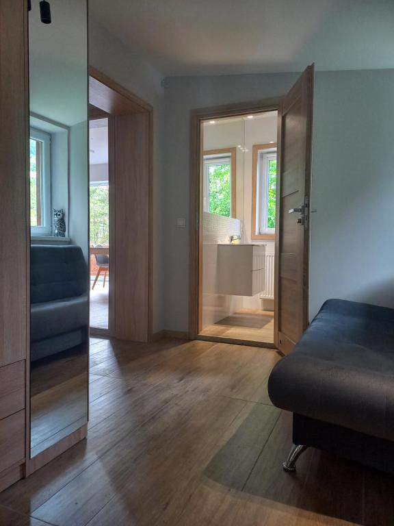 a bedroom with a bed and a door leading to a bathroom at 4 Sowy in Szczawnica