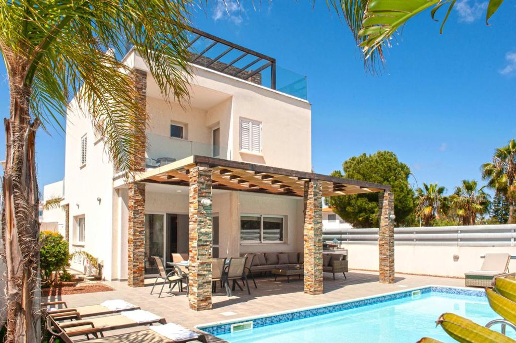 a villa with a swimming pool and a house at Villa Anastasia in Protaras